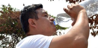 Hombre manteniéndose hidratado para prevenir un golpe de calor. Foto La Hora: MSPAS
